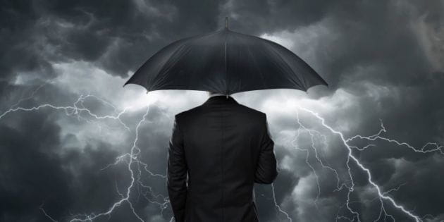 8273-trial_trouble_dark_clouds_umbrella_man.630w.tn.jpg